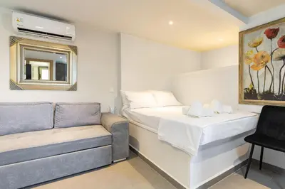 a small room with a bed and a couch at Panorama View Apt with Jacuzzi by 8essentially in Daratso