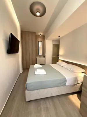 a bedroom with a bed with two towels on it at Kia's city retreat in Chania Town
