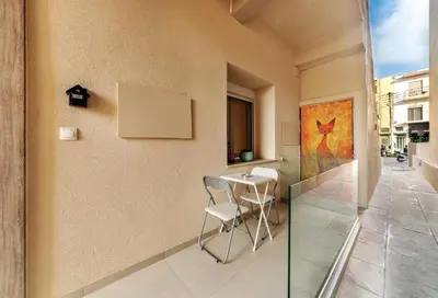 a room with a table and chairs in a building at Kia's city retreat in Chania Town