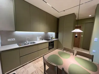 a kitchen with a table and chairs and a sink at Kia's city retreat in Chania Town
