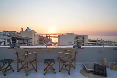 a balcony with chairs and a view of the ocean at Porta Harenae Residencia in Chania Town