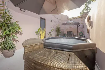 an outdoor bath tub in a patio with plants at Comfinest in Chania Town
