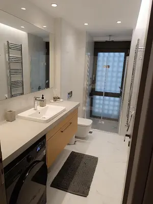 a bathroom with a sink and a toilet and a mirror at The Athena Apartment, Chania Seaside in Chania Town