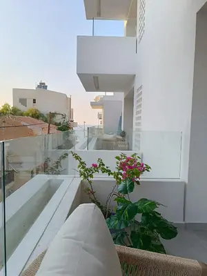 a view from the balcony of a house with a plant at The Athena Apartment, Chania Seaside in Chania Town