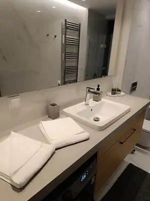 a bathroom with a sink and a mirror at The Athena Apartment, Chania Seaside in Chania Town