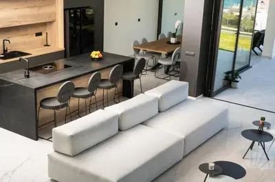 a living room with a couch and a table at Paradise Hill Luxury Villa in Kalyves