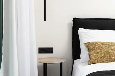a bedroom with a bed with a table next to it at Paradise Hill Luxury Villa in Kalyves