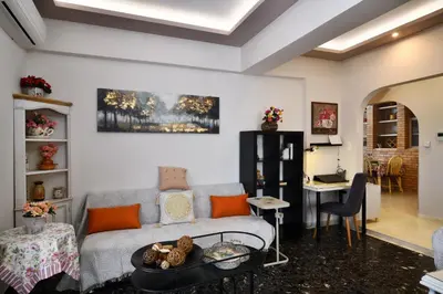 a living room with a couch and a table at Favola Golden Beach Villa in Daratso
