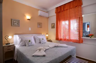 a bedroom with a bed with two towels on it at Favola Golden Beach Villa in Daratso
