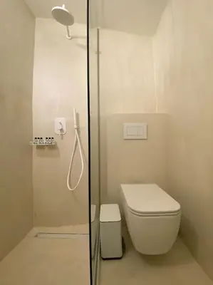 a white bathroom with a shower and a toilet at Teviot, 
