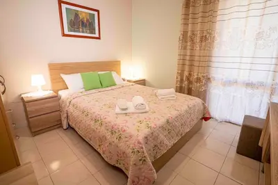 a bedroom with a bed with two shoes on it at Villa Marianna Lygides in Ayiá