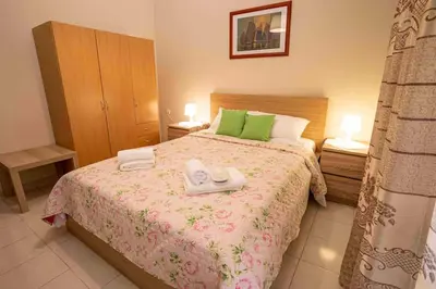 a bedroom with a bed with two towels on it at Villa Marianna Lygides in Ayiá