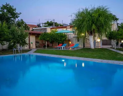 a large blue swimming pool in front of a house at Villa Marianna Lygides in Ayiá
