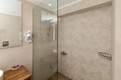 a shower with a glass door in a bathroom at Villa Elpida in Myloniana in Milonianá