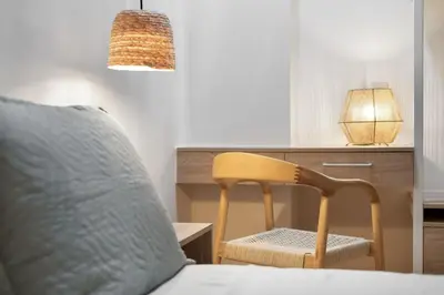 a bedroom with a bed and a desk with a chair at Leo Apartment 2 bdr apt overlooking the harbor in Chania Town
