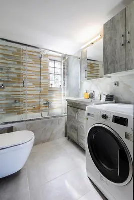 a white bathroom with a washing machine in it at Villa Cicada Chania, steps from the beach, Car included in Agia Marina Nea Kydonias
