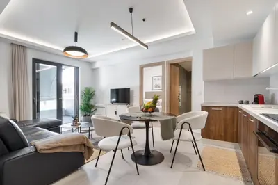 a kitchen and living room with a table and chairs at Comfy Apt terrace and parking 800m to old town and beach in Chania Town