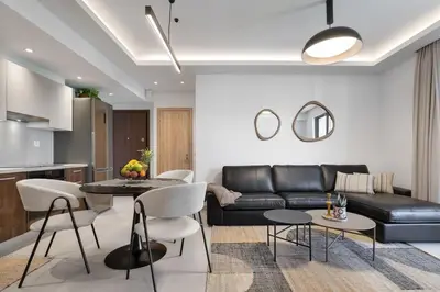 a living room with a couch and a table and chairs at Comfy Apt terrace and parking 800m to old town and beach in Chania Town
