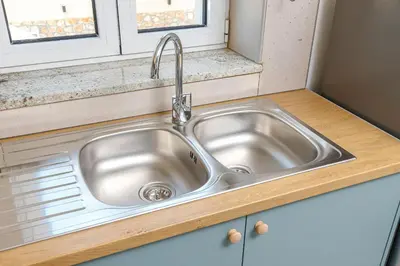 a stainless steel sink in a kitchen with a window at Meli apartments Paleochora in Palaiochóra