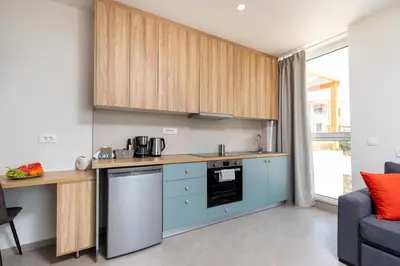 a kitchen with blue cabinets and a counter at Meli apartments Paleochora in Palaiochóra