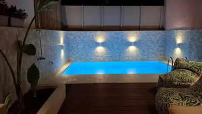 a swimming pool in a room with lights on it at Luxious Holiday Apt in Chania Town