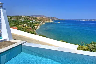 a swimming pool with a view of the ocean at Villa Sapphire by PosarelliVillas in Almirida