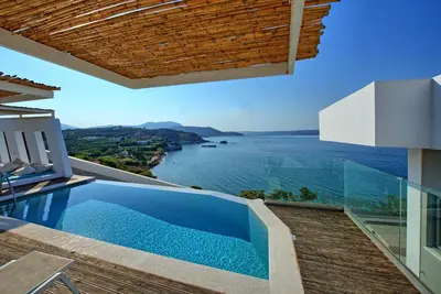 a villa with a swimming pool and a view of the ocean at Villa Sapphire by PosarelliVillas in Almirida