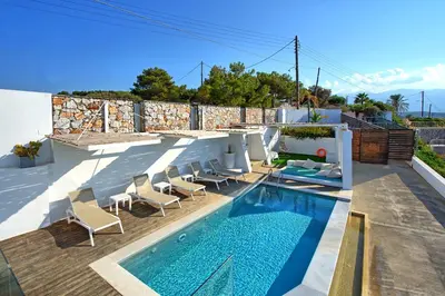 a swimming pool on the roof of a house at Villa Sapphire by PosarelliVillas in Almirida