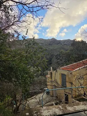 a building with a view of a mountain at Κρητικό Σπίτι Στον Παράδεισο in Palaiochóra