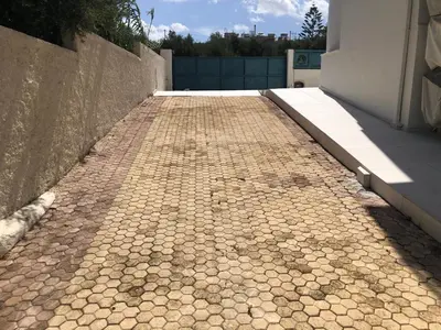 a cobblestone walkway in front of a building at Helen in Pírgos Psilonérou