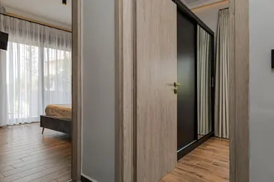 a hallway with a door leading to a bedroom at Noir Residence - Chic 2Br House Near Maleme Beach in Maleme