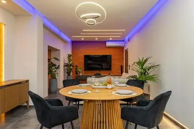 a dining room with a table and chairs at Noir Residence - Chic 2Br House Near Maleme Beach in Maleme