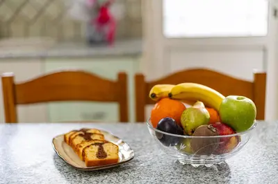a bowl of fruit on a table with a plate of bread at Large Cozy House near the sea - Kolimvari Village - 6 Pax in Kolymvari