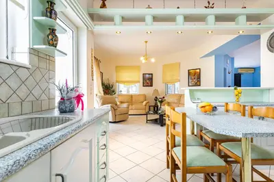 a kitchen and living room with a counter and chairs at Large Cozy House near the sea - Kolimvari Village - 6 Pax in Kolymvari