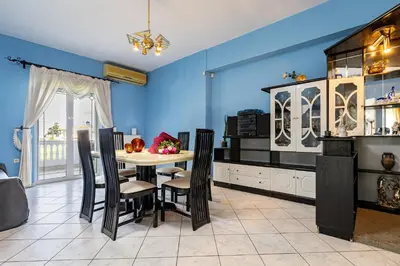 a dining room with blue walls and a table and chairs at Large Cozy House near the sea - Kolimvari Village - 6 Pax in Kolymvari