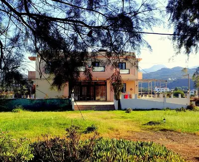 a house with a grass yard in front of it at Girogiali Apt 3 in Kamára