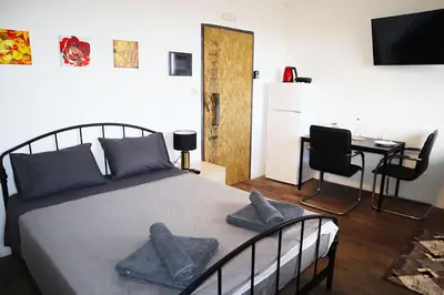 a bedroom with a bed with two pillows on it at Studio92 Chania in Chania Town