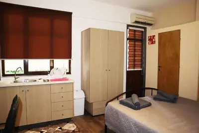 a small bedroom with a bed and a sink at Studio92 Chania in Chania Town