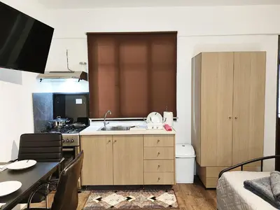 a small kitchen with a sink and a table at Studio92 Chania in Chania Town
