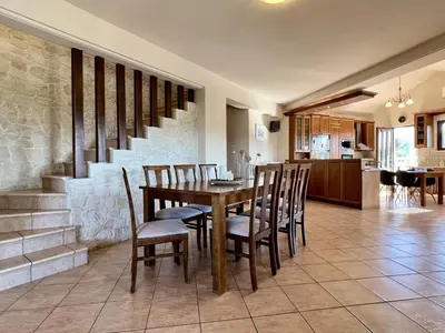 a dining room and kitchen with a table and chairs at Villa Metapothia Gavalochori Crete in Gavalochori