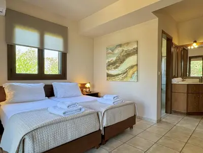 a bedroom with a bed with towels on it at Villa Metapothia Gavalochori Crete in Gavalochori