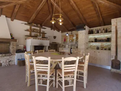 a kitchen and dining room with a table and chairs at Villa Amvrosia Nr Kalives Crete in Arménoi