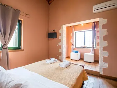 a bedroom with two beds and a window at Villa Amvrosia Nr Kalives Crete in Arménoi
