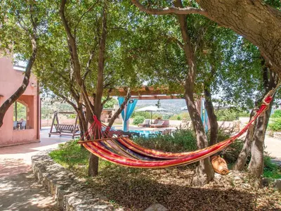a hammock hanging from a tree in a garden at Villa Galania Armeni Crete in Arménoi