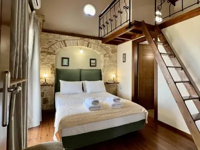 a bedroom with a large bed with towels on it at Villa Avra Vrisses Crete in Alikampos
