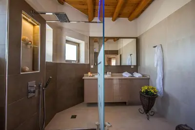 a bathroom with a shower and a sink at Villa Olivia with Pool Vrises Crete in Alikampos