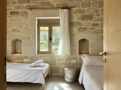 a bedroom with two beds and a window at Villa Olivia with Pool Vrises Crete in Alikampos