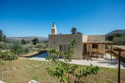 a stone house with a lighthouse on top of it at Villa Olivia with Pool Vrises Crete in Alikampos