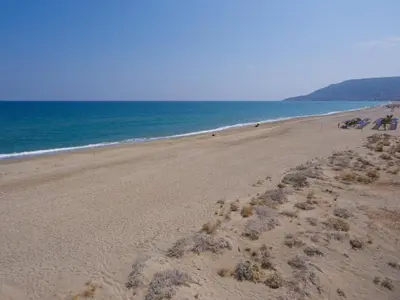 a sandy beach with the ocean in the background at Villa Olivia with Pool Vrises Crete in Alikampos