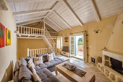 a living room with a couch and a table at Villa Vigla in Samonás